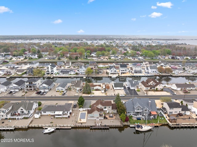birds eye view of property with a residential view and a water view