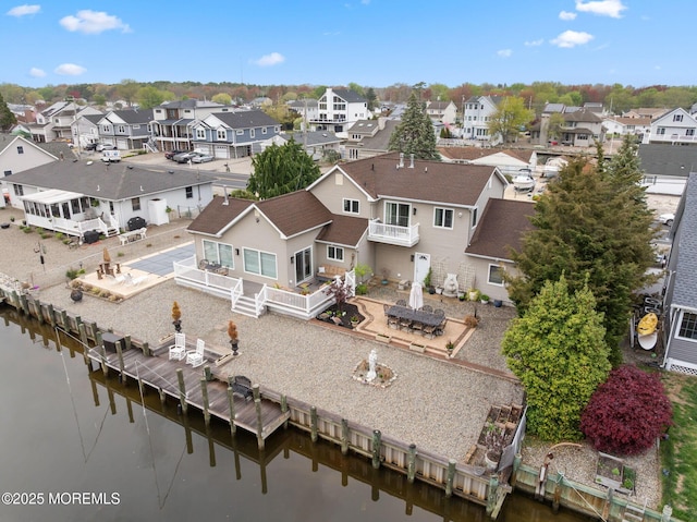 birds eye view of property with a residential view and a water view