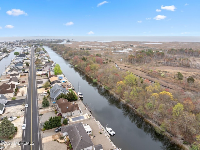bird's eye view featuring a water view and a residential view