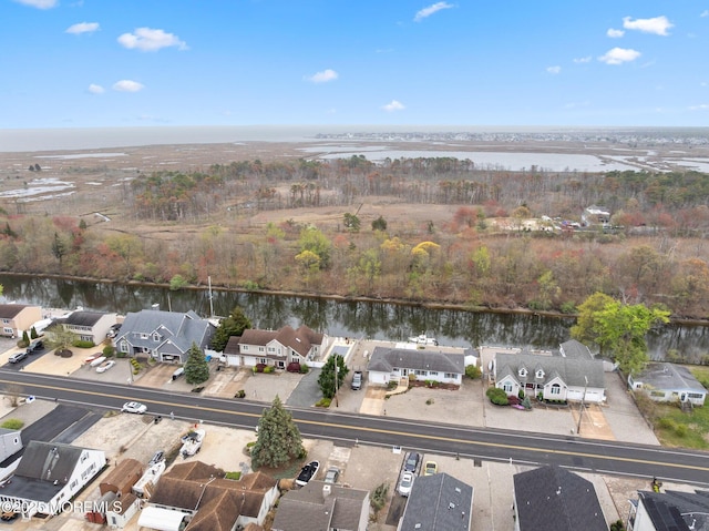 drone / aerial view with a residential view and a water view