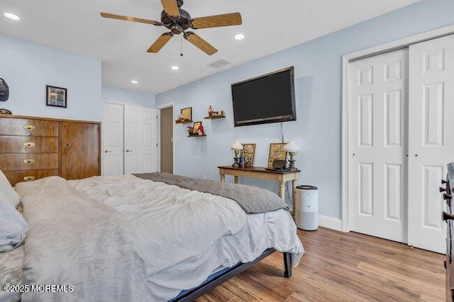 bedroom with ceiling fan, wood finished floors, baseboards, a closet, and recessed lighting