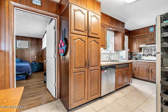 21 Dockage Rd, Bayville, NJ 08721 - kitchen featuring appliances with stainless steel finishes, wood walls, a wall mounted AC, light tile patterned floors, and light countertops