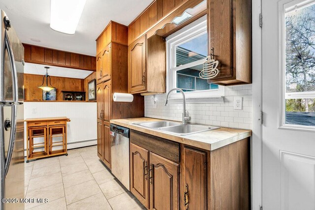 21 Dockage Rd, Bayville, NJ 08721 - kitchen with stainless steel appliances, a sink, light countertops, tasteful backsplash, and brown cabinets