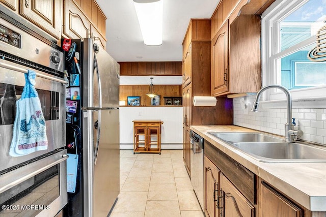 21 Dockage Rd, Bayville, NJ 08721 - kitchen with stainless steel appliances, a sink, light countertops, decorative backsplash, and brown cabinetry