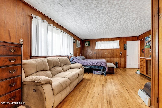 21 Dockage Rd, Bayville, NJ 08721 - bedroom with light wood-type flooring, wooden walls, and an AC wall unit