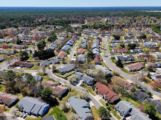 drone / aerial view featuring a view of trees and a residential view