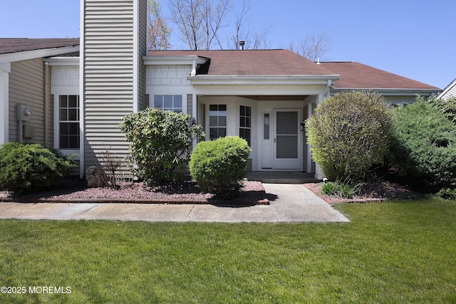 exterior space featuring a chimney and a front lawn