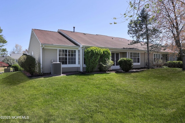 back of house featuring a lawn and central AC