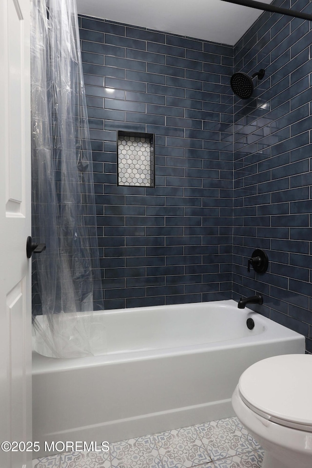 bathroom featuring tile patterned floors, shower / bath combination with curtain, and toilet