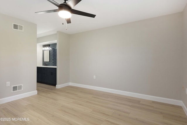 unfurnished room featuring light wood-type flooring, baseboards, and visible vents
