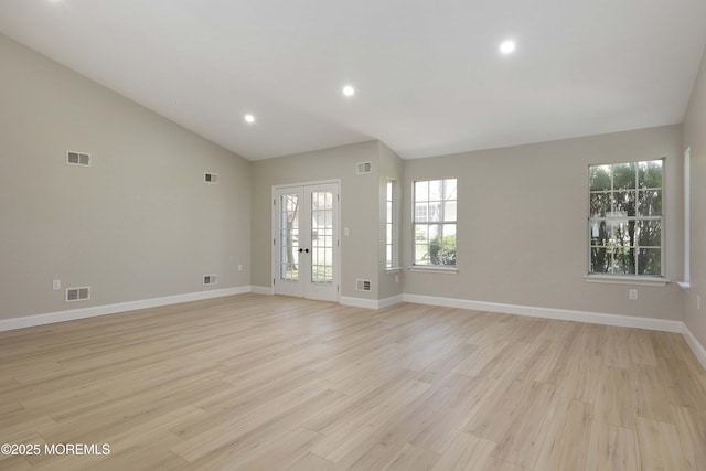 unfurnished living room with lofted ceiling and visible vents