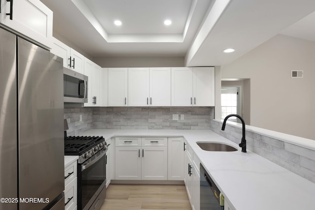 kitchen with recessed lighting, visible vents, appliances with stainless steel finishes, and a sink
