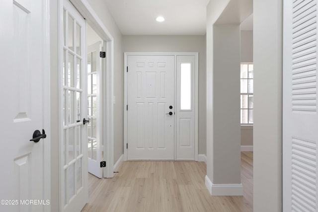 entrance foyer featuring recessed lighting, baseboards, french doors, and light wood-type flooring