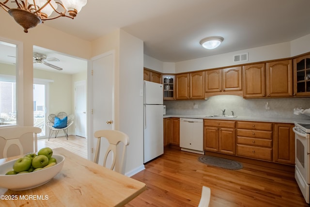 25 Meadow Ave Unit 64, Monmouth Beach, NJ 07750 - kitchen with white appliances, a sink, brown cabinets, and glass insert cabinets