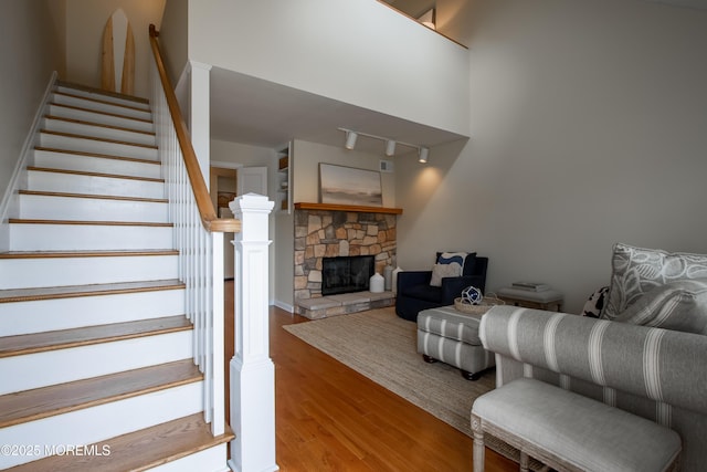 25 Meadow Ave Unit 64, Monmouth Beach, NJ 07750 - living room with wood finished floors, stairs, and a stone fireplace