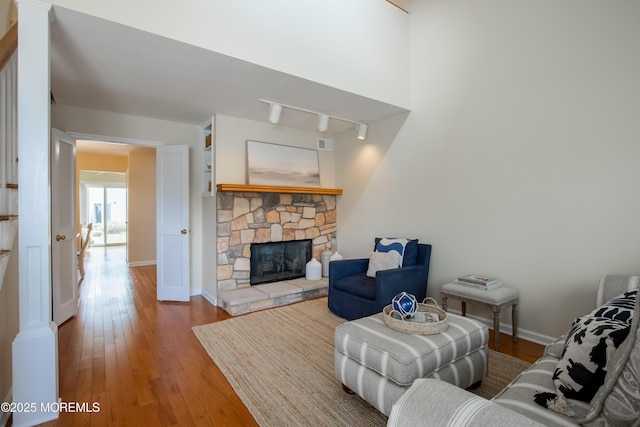 25 Meadow Ave Unit 64, Monmouth Beach, NJ 07750 - living room with wood finished floors, a fireplace, and baseboards