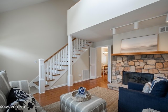 25 Meadow Ave Unit 64, Monmouth Beach, NJ 07750 - living room featuring stairs, wood finished floors, a chandelier, and a fireplace