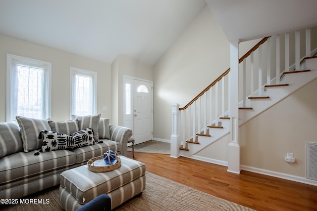 25 Meadow Ave Unit 64, Monmouth Beach, NJ 07750 - living room featuring wood finished floors, stairs, baseboards, and high vaulted ceiling