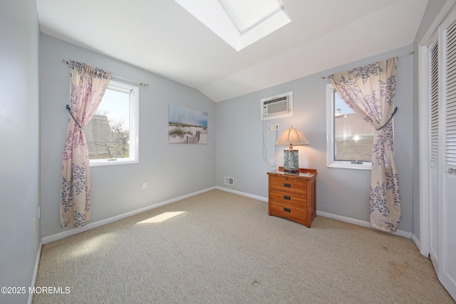 75 Gravelly Point Rd, Highlands, NJ 07732 - bedroom with baseboards, carpet, lofted ceiling with skylight, and a wall mounted AC