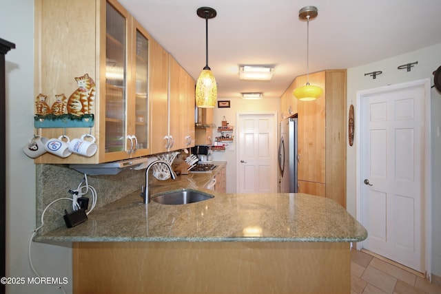 75 Gravelly Point Rd, Highlands, NJ 07732 - kitchen featuring decorative backsplash, a sink, light stone counters, freestanding refrigerator, and glass insert cabinets