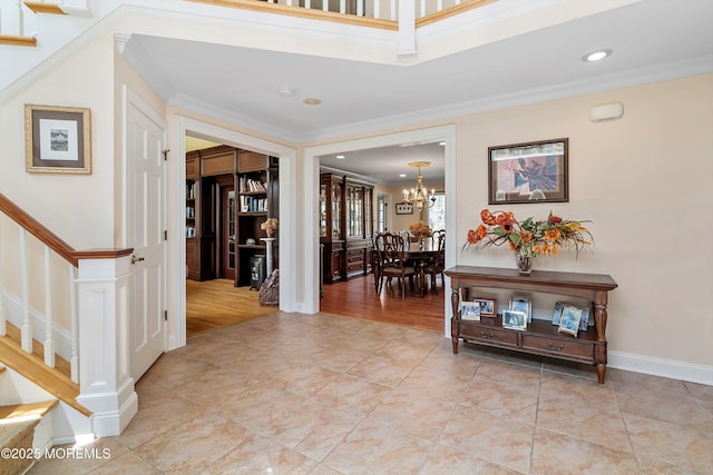 entryway featuring stairway, a notable chandelier, and crown molding