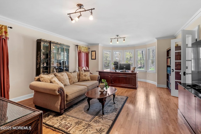 living room featuring light wood-type flooring, crown molding, and baseboards
