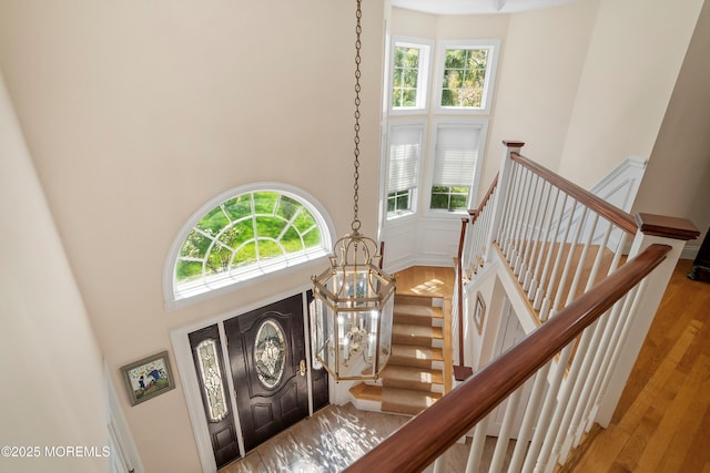 entryway with a towering ceiling, a wealth of natural light, and stairs