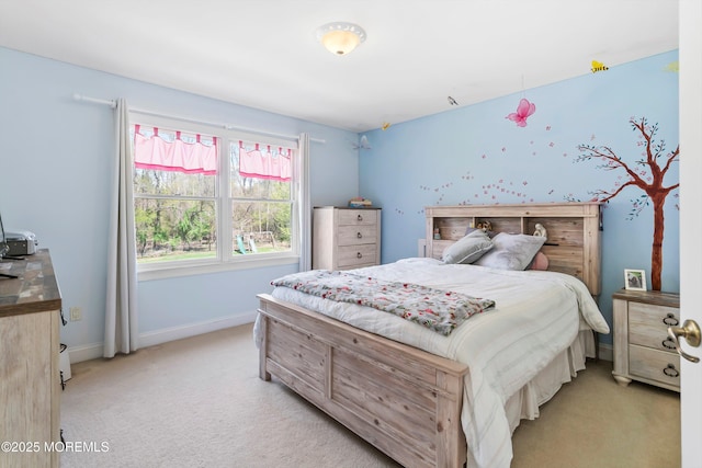 bedroom with baseboards and light carpet