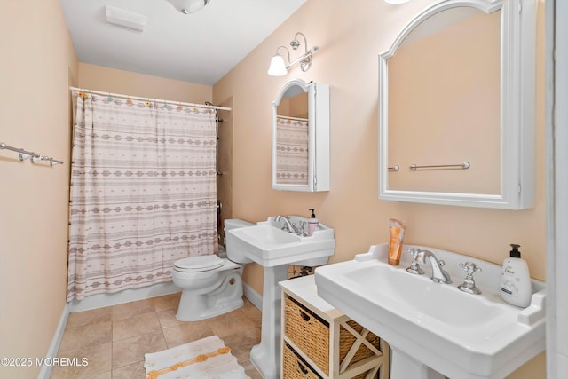 full bathroom featuring tile patterned flooring, toilet, baseboards, and a sink