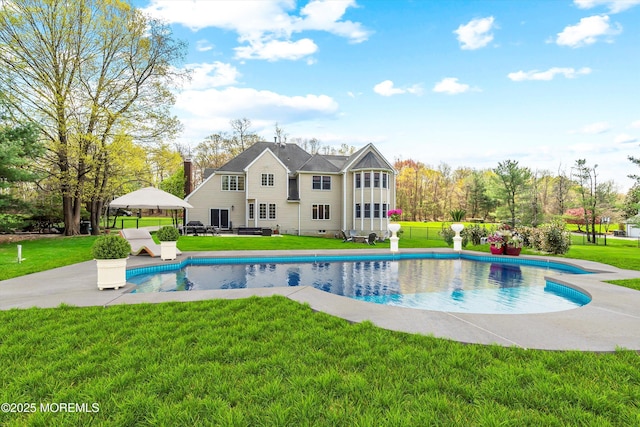 pool with a yard and a patio