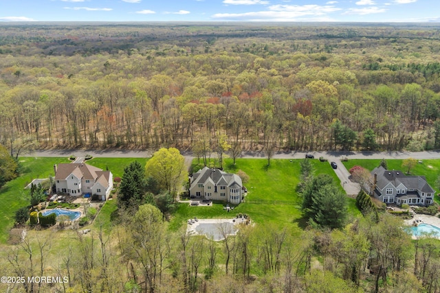 aerial view featuring a wooded view