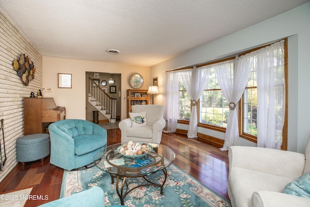 12 Millstream Rd, Cream Ridge, NJ 08514 - living room with hardwood / wood-style flooring, a textured ceiling, stairway, baseboards, and brick wall