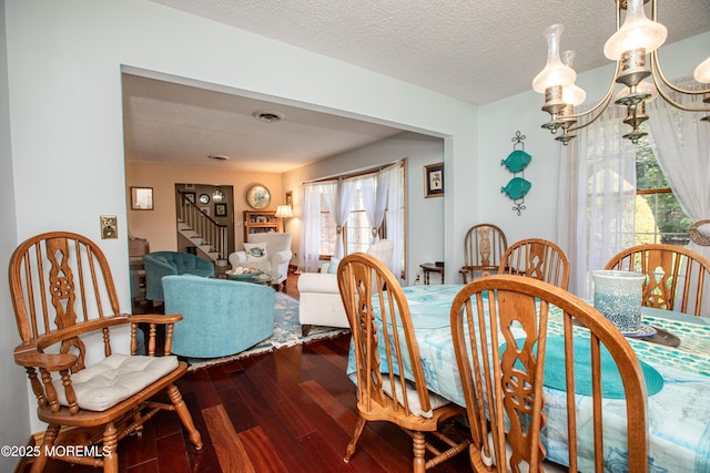 12 Millstream Rd, Cream Ridge, NJ 08514 - dining area featuring dark wood finished floors, a textured ceiling, and stairway