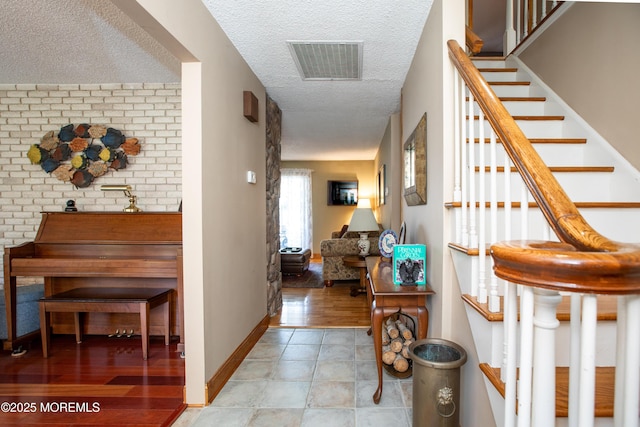 12 Millstream Rd, Cream Ridge, NJ 08514 - corridor featuring a textured ceiling, stairs, and light tile patterned floors
