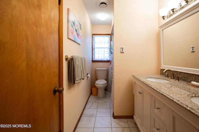 12 Millstream Rd, Cream Ridge, NJ 08514 - bathroom with a sink, toilet, marble finish floor, a textured ceiling, and double vanity