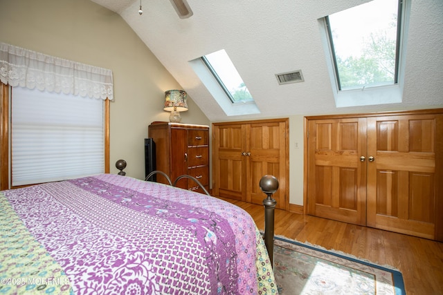 12 Millstream Rd, Cream Ridge, NJ 08514 - bedroom with ceiling fan, visible vents, wood finished floors, and vaulted ceiling with skylight