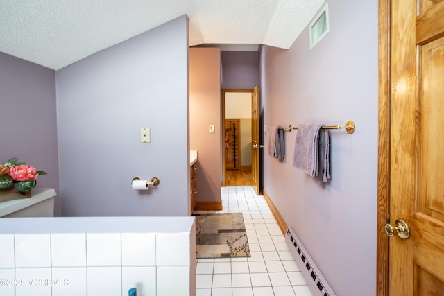 12 Millstream Rd, Cream Ridge, NJ 08514 - bathroom with tile patterned floors, a textured ceiling, visible vents, and a baseboard heating unit