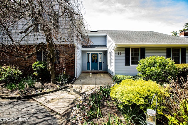 12 Millstream Rd, Cream Ridge, NJ 08514 - view of exterior entry featuring roof with shingles and a chimney