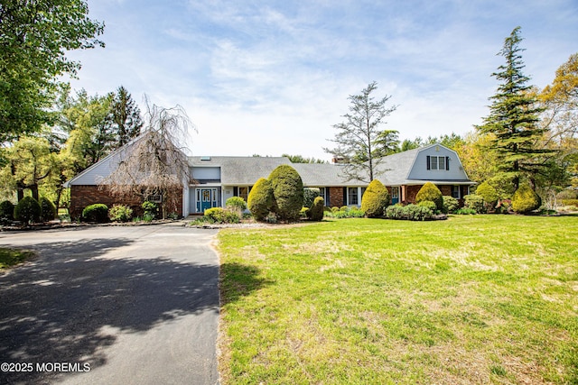 12 Millstream Rd, Cream Ridge, NJ 08514 - view of front of home with aphalt driveway, a front lawn, and brick siding
