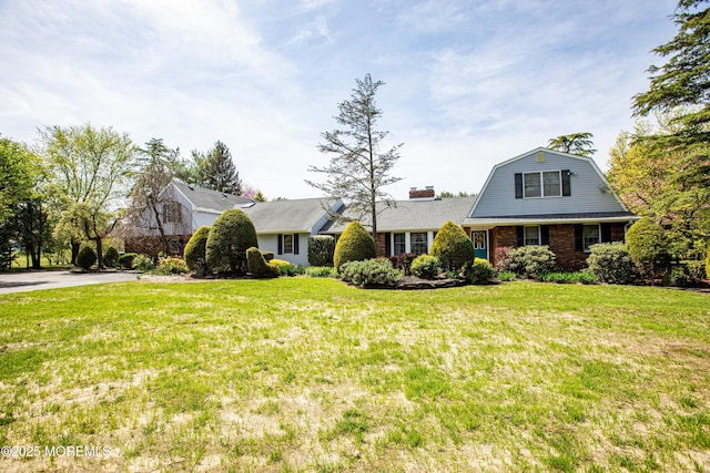 12 Millstream Rd, Cream Ridge, NJ 08514 - view of front of home with a gambrel roof, a front lawn, and brick siding