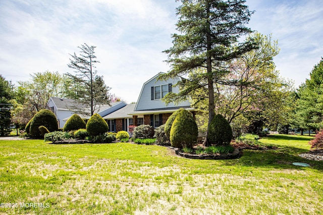 12 Millstream Rd, Cream Ridge, NJ 08514 - view of front facade with a gambrel roof, a front lawn, and brick siding