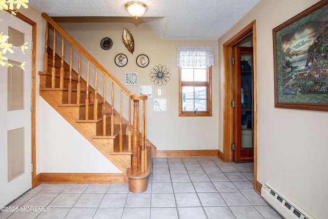 12 Millstream Rd, Cream Ridge, NJ 08514 - foyer featuring light tile patterned floors, stairs, a baseboard radiator, and a textured ceiling