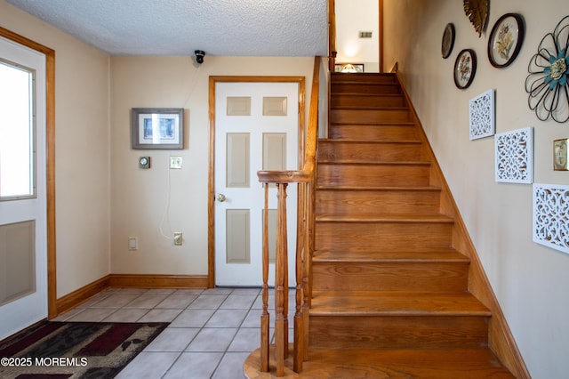12 Millstream Rd, Cream Ridge, NJ 08514 - stairs featuring a textured ceiling, visible vents, and tile patterned flooring