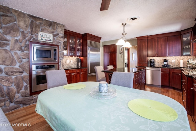 12 Millstream Rd, Cream Ridge, NJ 08514 - dining room with a textured ceiling, visible vents, and wood finished floors