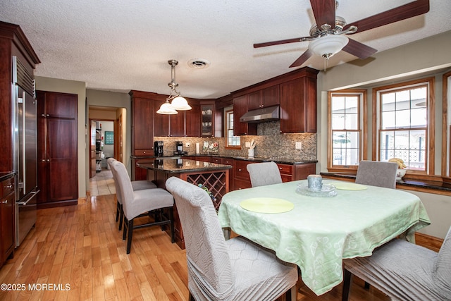 12 Millstream Rd, Cream Ridge, NJ 08514 - dining space featuring ceiling fan, light wood-style floors, a healthy amount of sunlight, and a textured ceiling