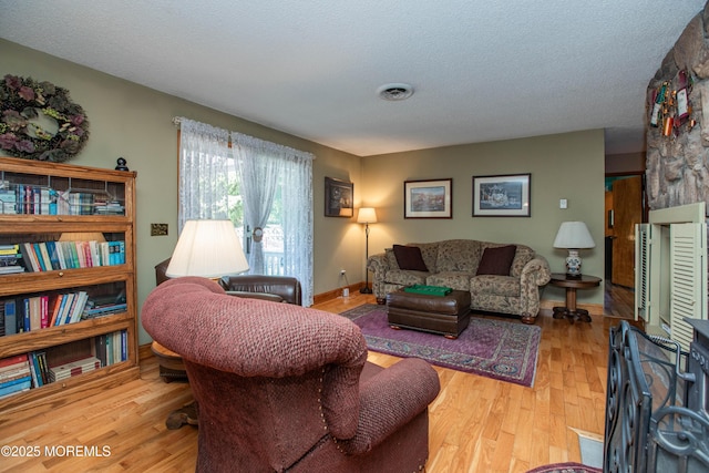 12 Millstream Rd, Cream Ridge, NJ 08514 - living room with wood finished floors, a textured ceiling, and baseboards