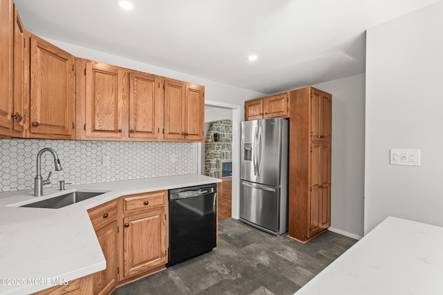 kitchen with black dishwasher, stainless steel refrigerator with ice dispenser, recessed lighting, a sink, and backsplash