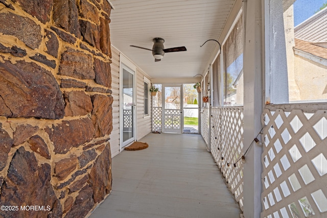 wooden deck featuring a porch and ceiling fan