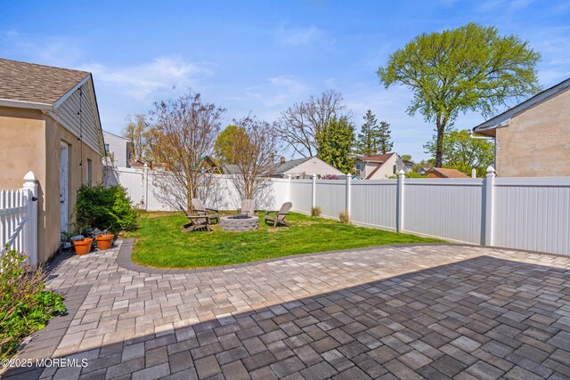 view of patio / terrace featuring a residential view, a fire pit, and a fenced backyard