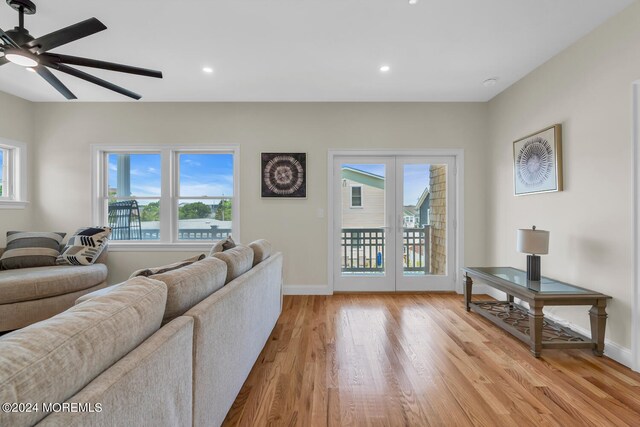 living room featuring a ceiling fan, light wood-type flooring, french doors, baseboards, and recessed lighting